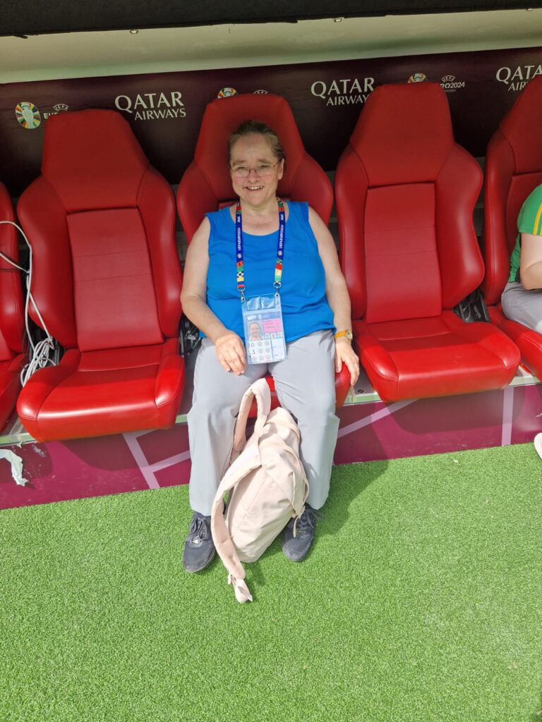 Lisbeth sitzt auf der Trainerbank der Allianz Arena